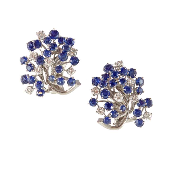 Pair of sapphire and diamond cluster earrings, attributed to Oscar Heyman, in the form of stylised budding sprays,